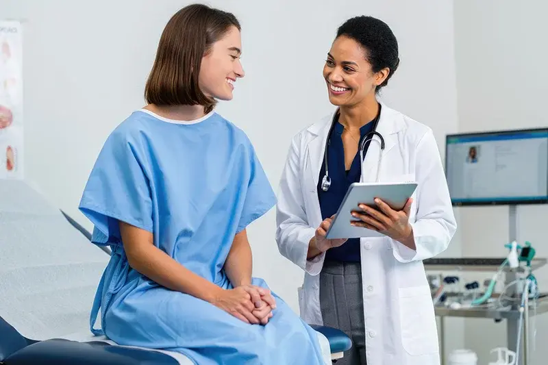 Doctor and female patient smiling